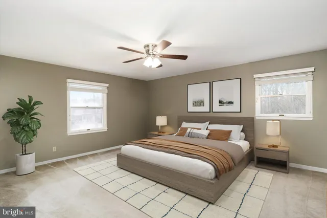 a bathroom with a granite countertop toilet sink and mirror