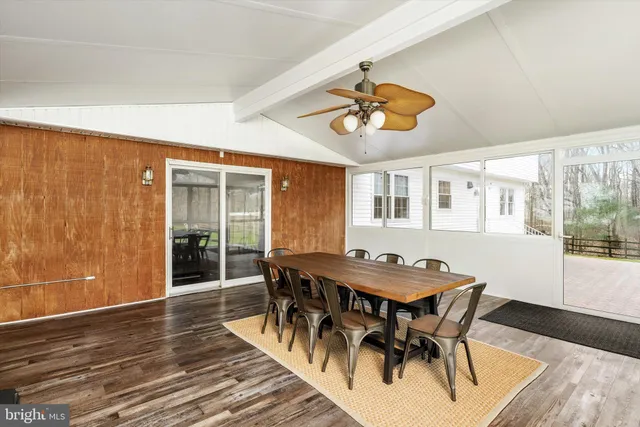a view of a house with a yard and wooden fence