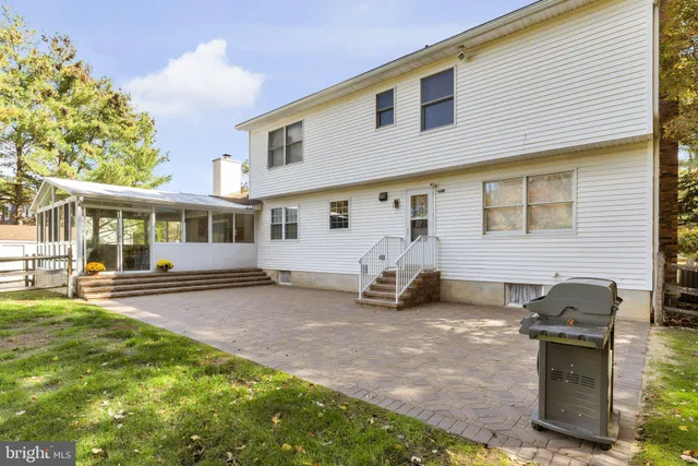 a front view of a house with a yard table and chairs