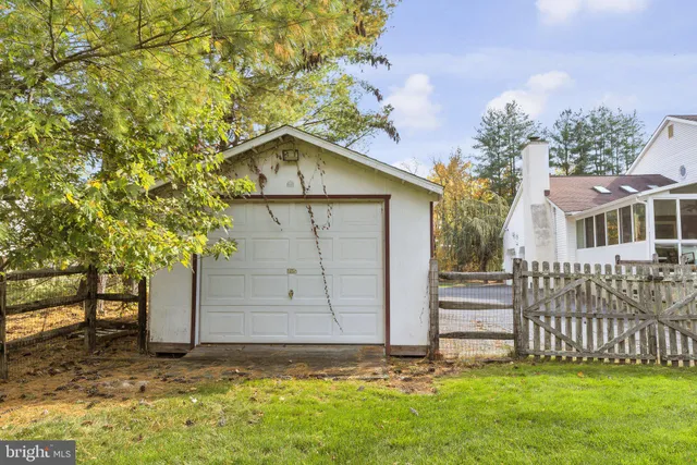 a aerial view of a house next to a big yard and large trees