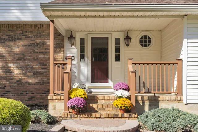 a front view of a house with outdoor seating