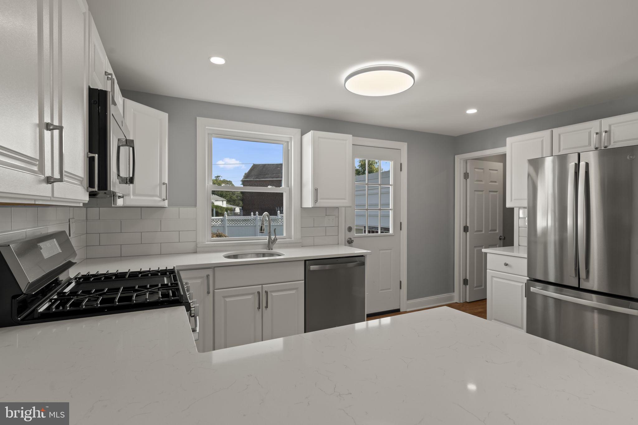 416 Adair Road Holmes, PA 19043 - Photo 10 of 32 a kitchen with stainless steel appliances a sink stove and refrigerator