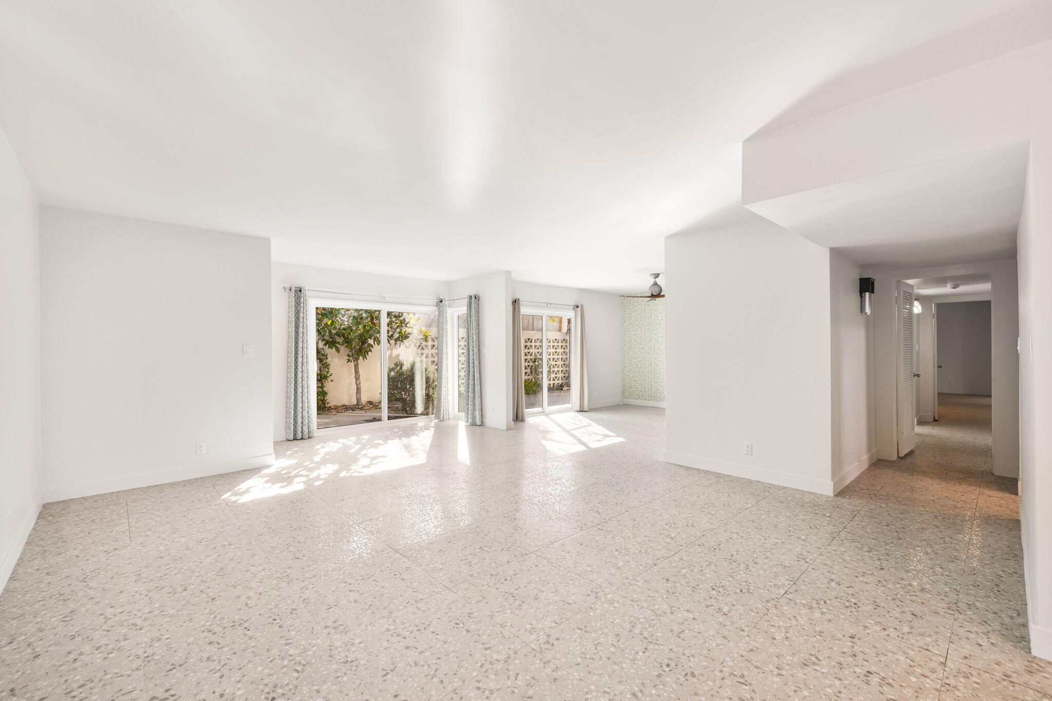 1810 Sandcliff Road Palm Springs, CA 92264 - Photo 13 of 55 a view of a big room with windows and chandelier