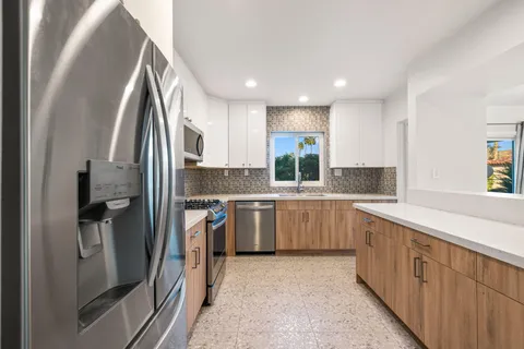 a view of a kitchen that has a sink and a window