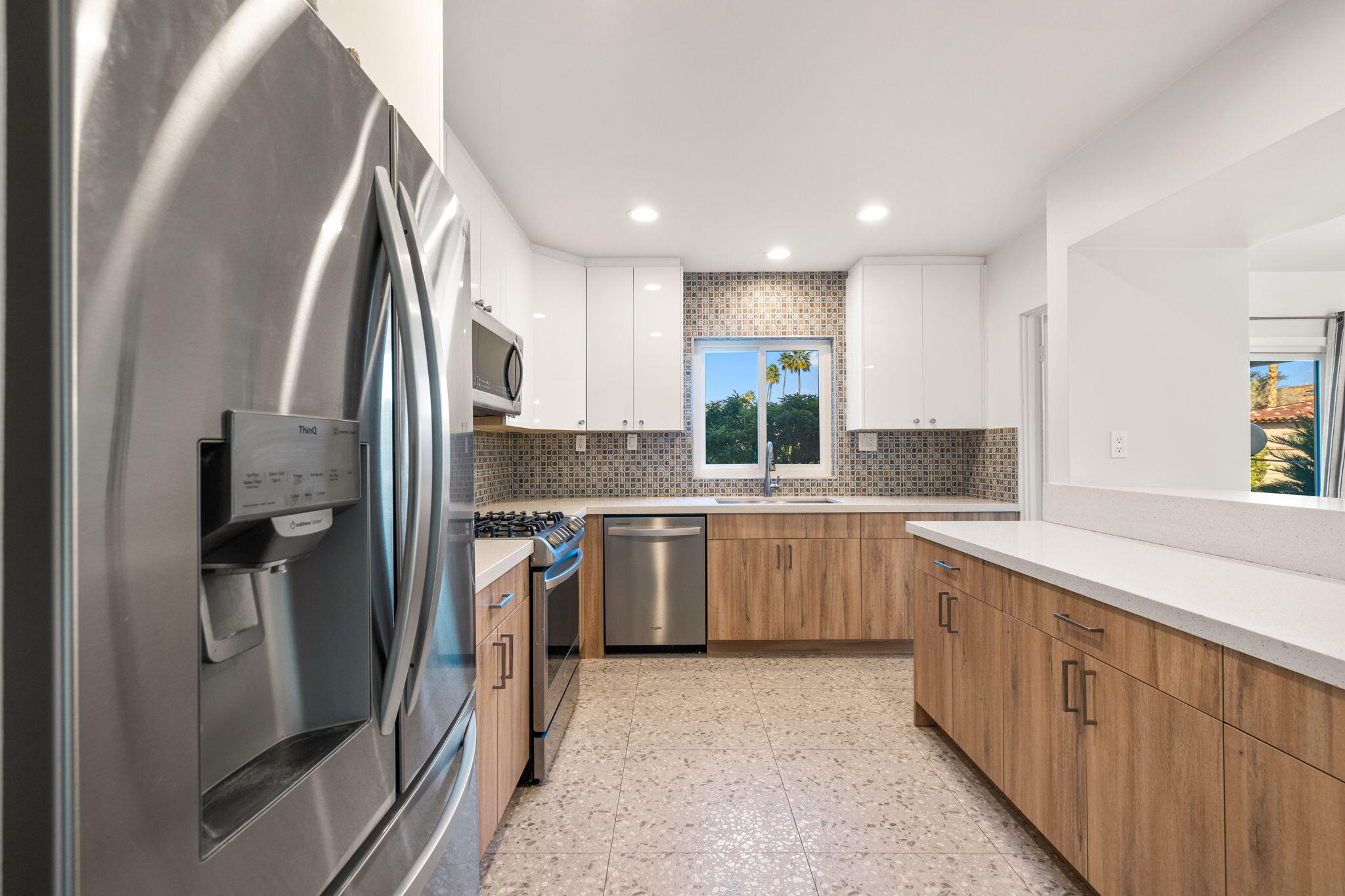 1810 Sandcliff Road Palm Springs, CA 92264 - Photo 19 of 55 a kitchen with a sink refrigerator and cabinets