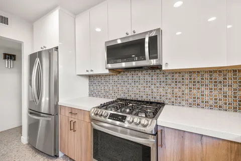 a kitchen with a sink stove and refrigerator