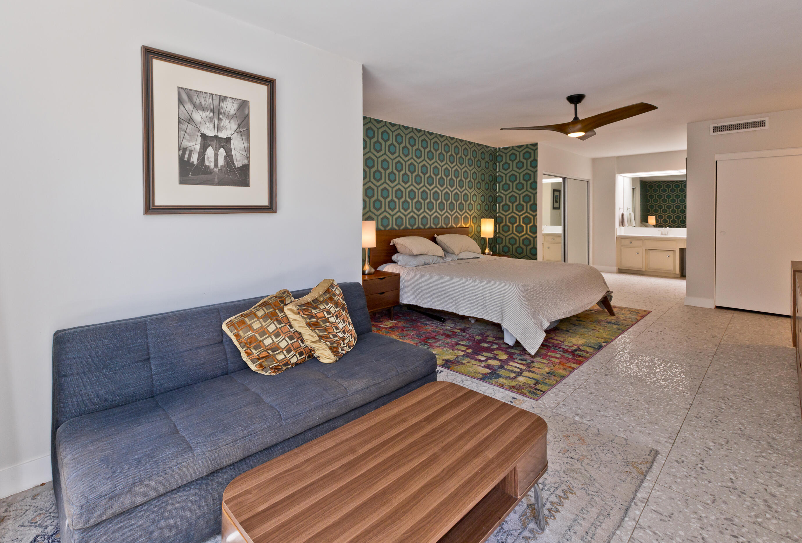 1810 Sandcliff Road Palm Springs, CA 92264 - Photo 25 of 55 a living room with couches coffee table and paintings on the wall