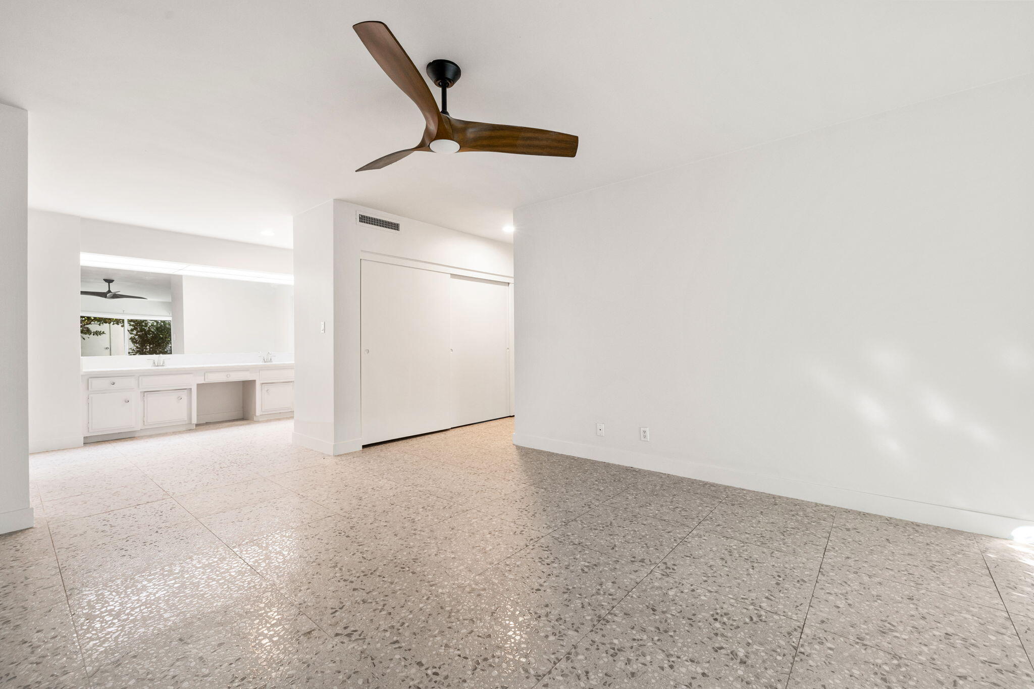 1810 Sandcliff Road Palm Springs, CA 92264 - Photo 26 of 55 an empty room with a kitchen space and a ceiling fan