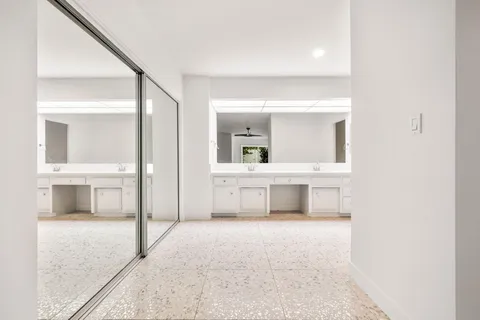 a view of an empty room and a window