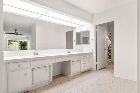 a bedroom with two beds and a chandelier