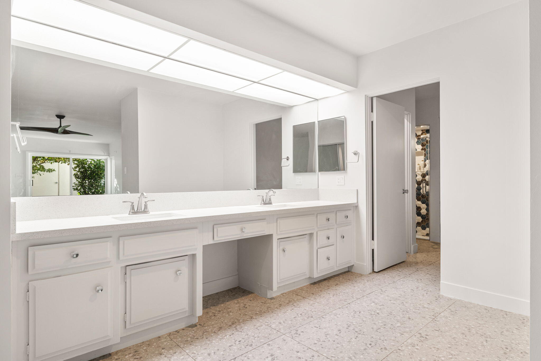 1810 Sandcliff Road Palm Springs, CA 92264 - Photo 30 of 55 a spacious bathroom with a double vanity sink and mirror