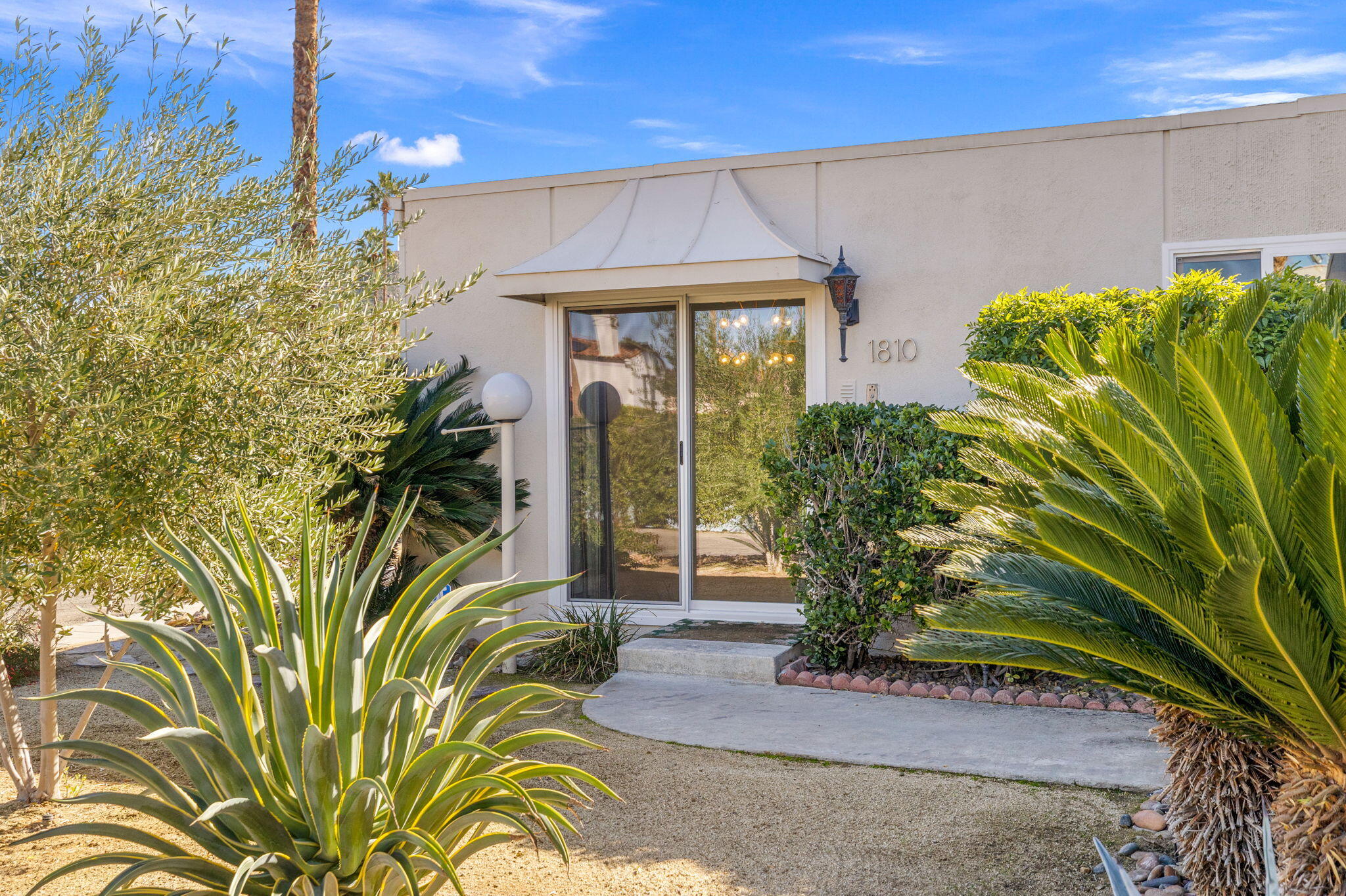 1810 Sandcliff Road Palm Springs, CA 92264 - Photo 42 of 55 a front view of a house with garden