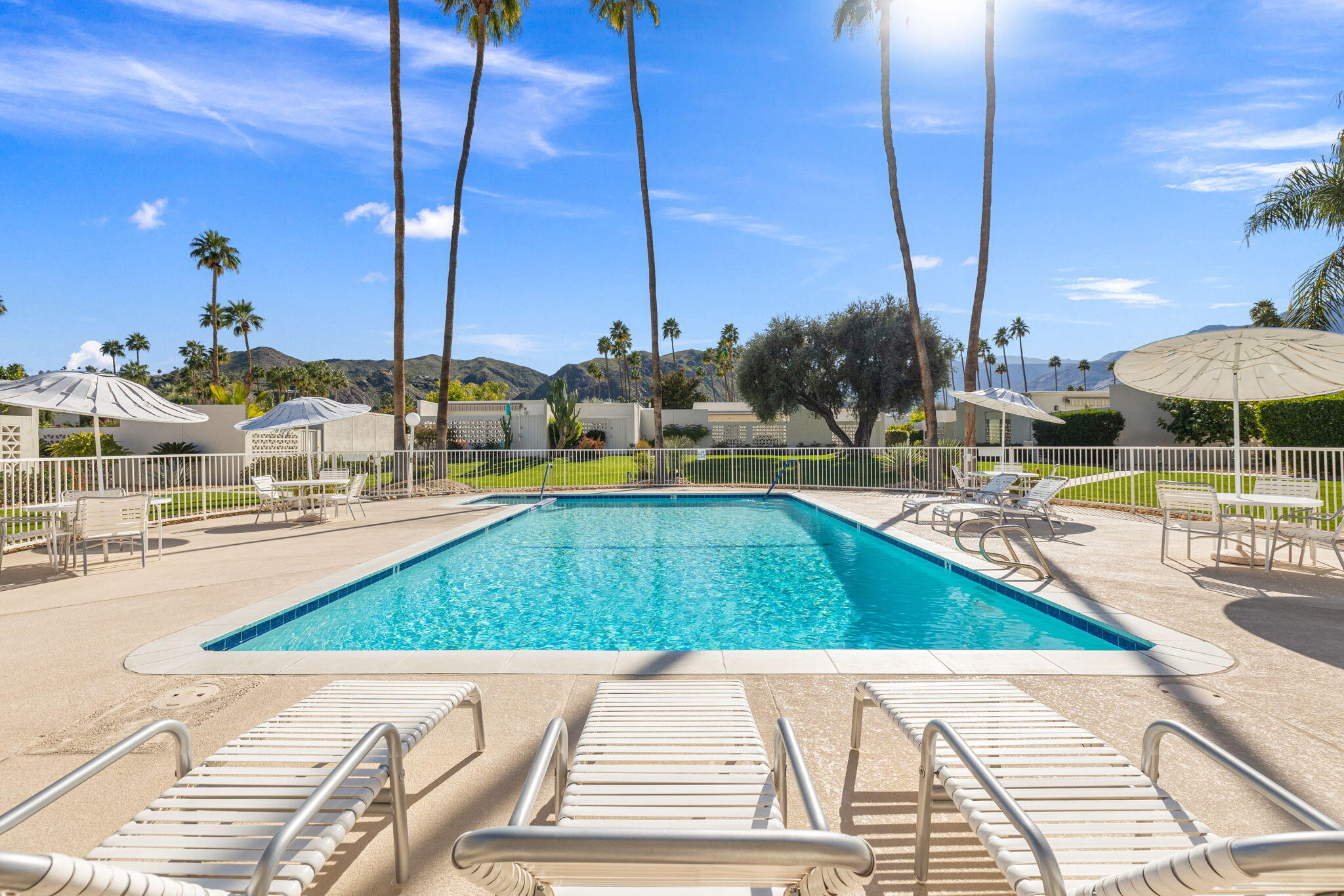 1810 Sandcliff Road Palm Springs, CA 92264 - Photo 44 of 55 a view of a swimming pool with a lounge chairs