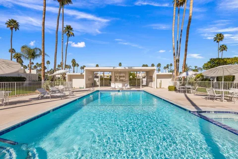 a view of a swimming pool with a lawn chairs