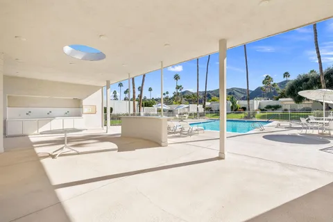 a swimming pool with outdoor seating and yard
