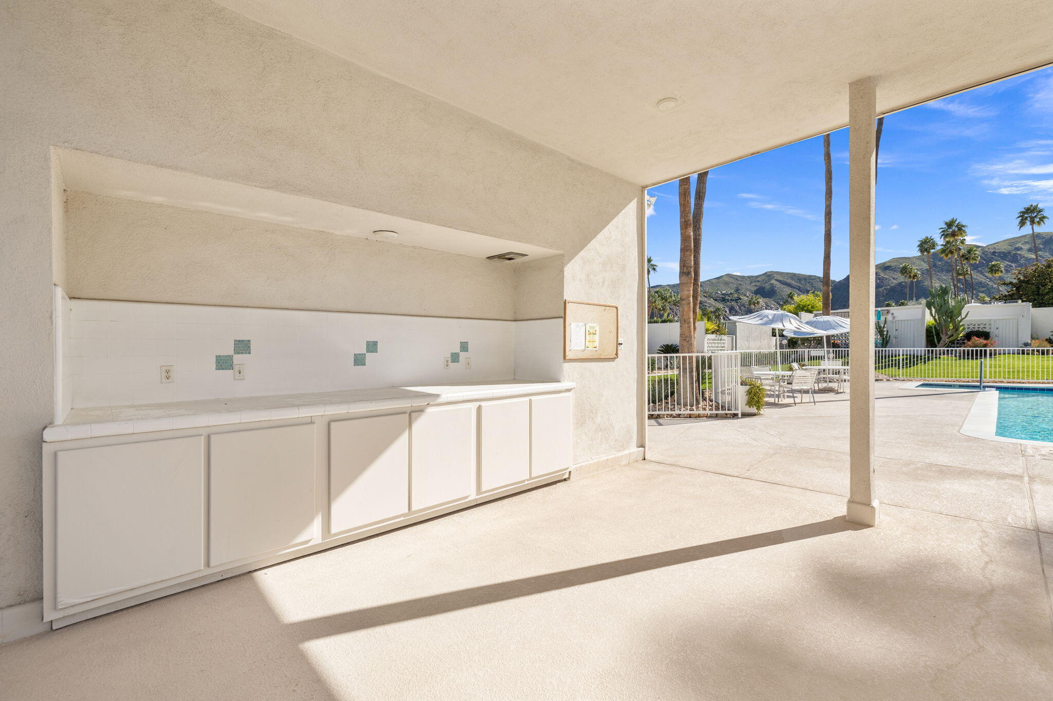 1810 Sandcliff Road Palm Springs, CA 92264 - Photo 47 of 55 a view of a kitchen with white cabinets and a stove top oven