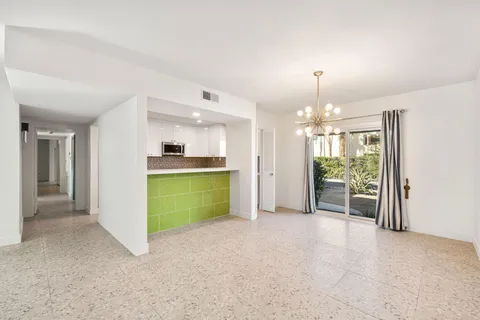 a view of a kitchen and a kitchen with a sink cabinets