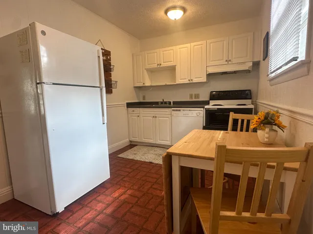 a kitchen with kitchen island a sink appliances and cabinets