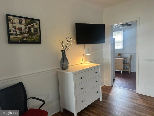 a room with a chair and a flat screen tv