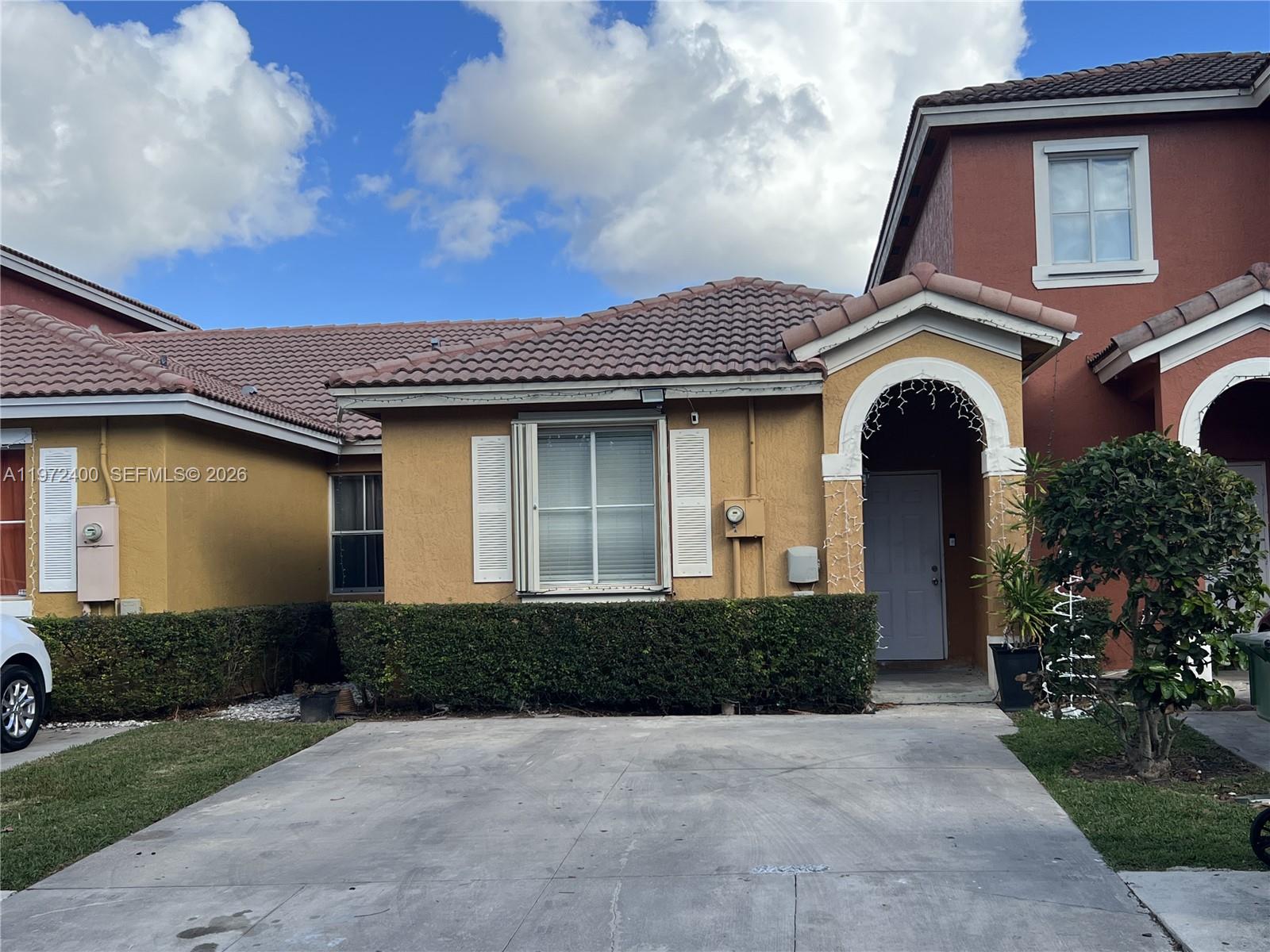 95 Southwest 15th Road Homestead, FL 33030 - Photo 1 of 42 a front view of a house with garden