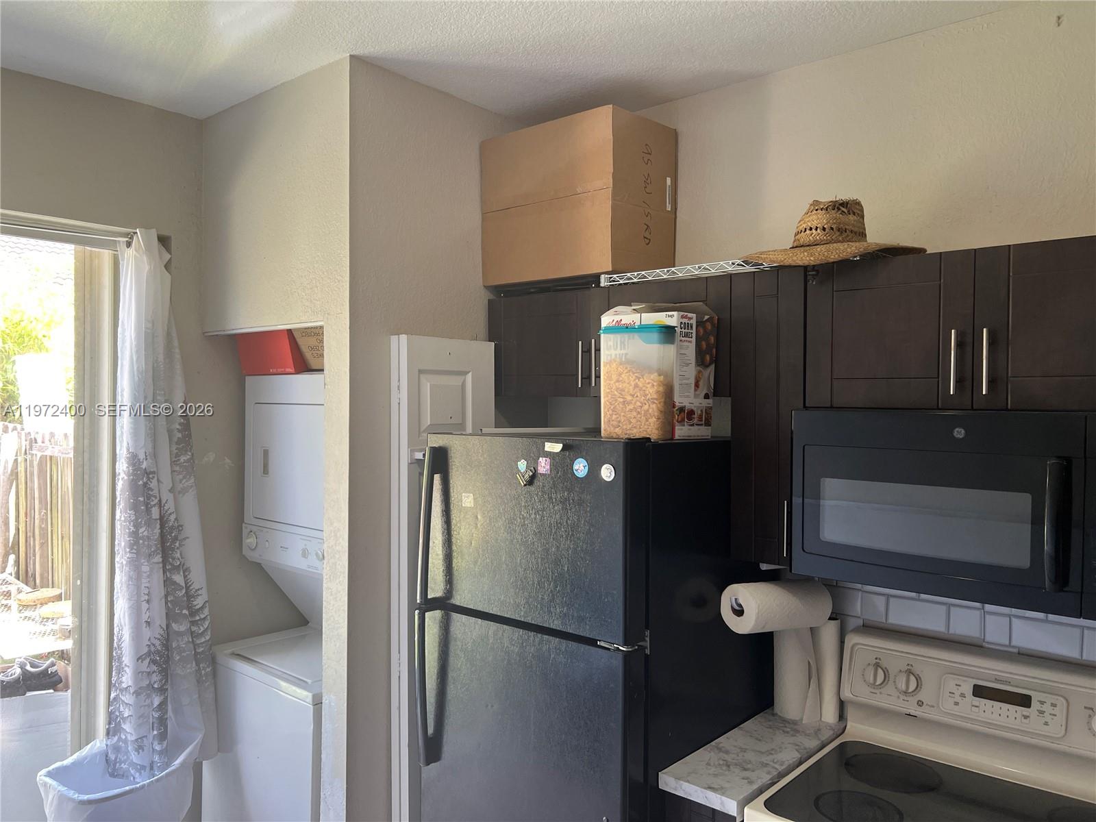 95 Southwest 15th Road Homestead, FL 33030 - Photo 11 of 42 a kitchen with a refrigerator and a stove top oven