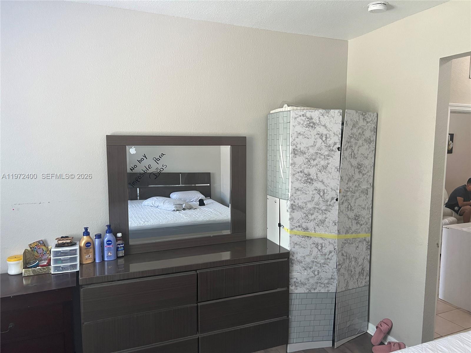 95 Southwest 15th Road Homestead, FL 33030 - Photo 18 of 42 a bedroom with a bed and a mirror