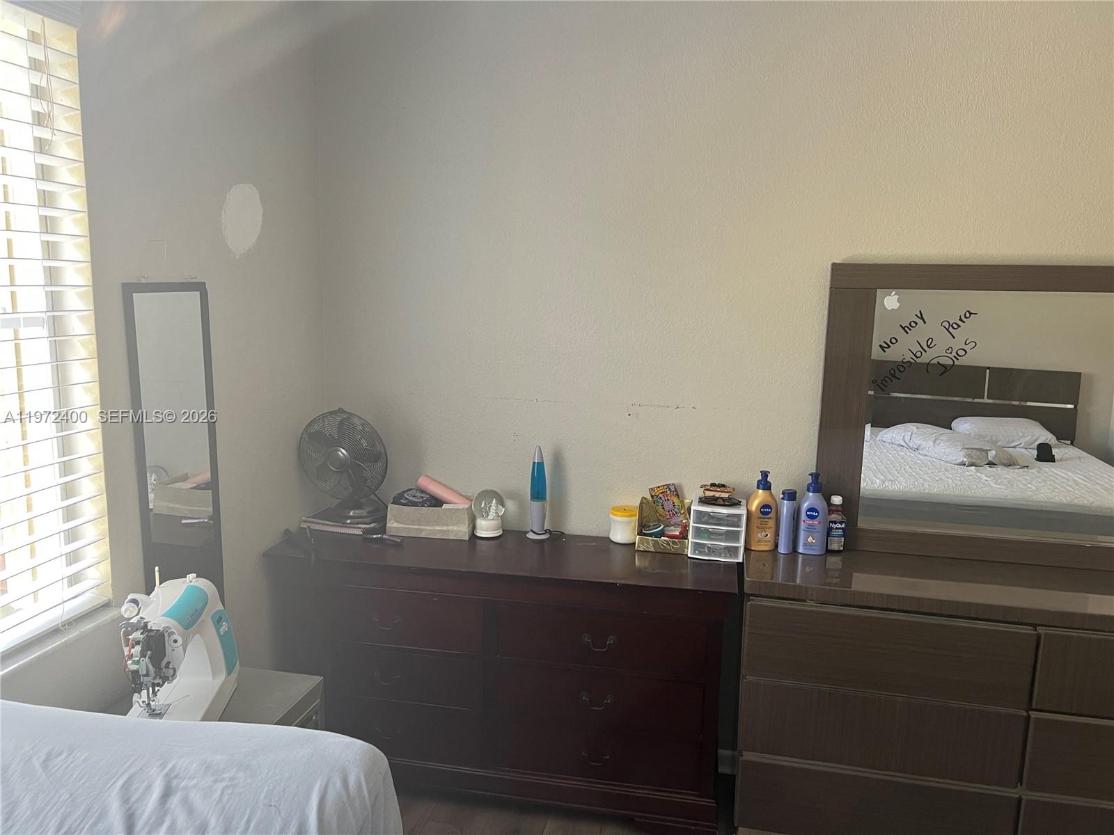 95 Southwest 15th Road Homestead, FL 33030 - Photo 19 of 42 a room with a bed and window