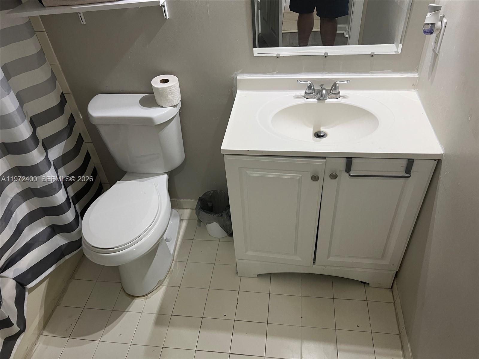 95 Southwest 15th Road Homestead, FL 33030 - Photo 20 of 42 a white toilet sitting next to a bathroom sink