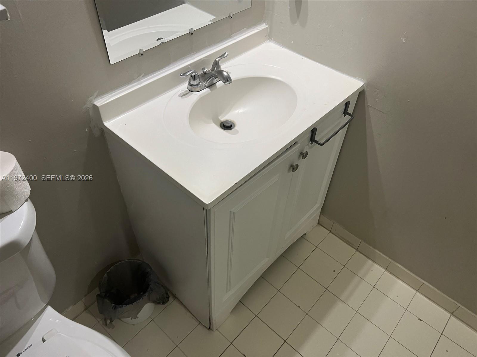 95 Southwest 15th Road Homestead, FL 33030 - Photo 23 of 42 a bathroom with a sink toilet and a mirror