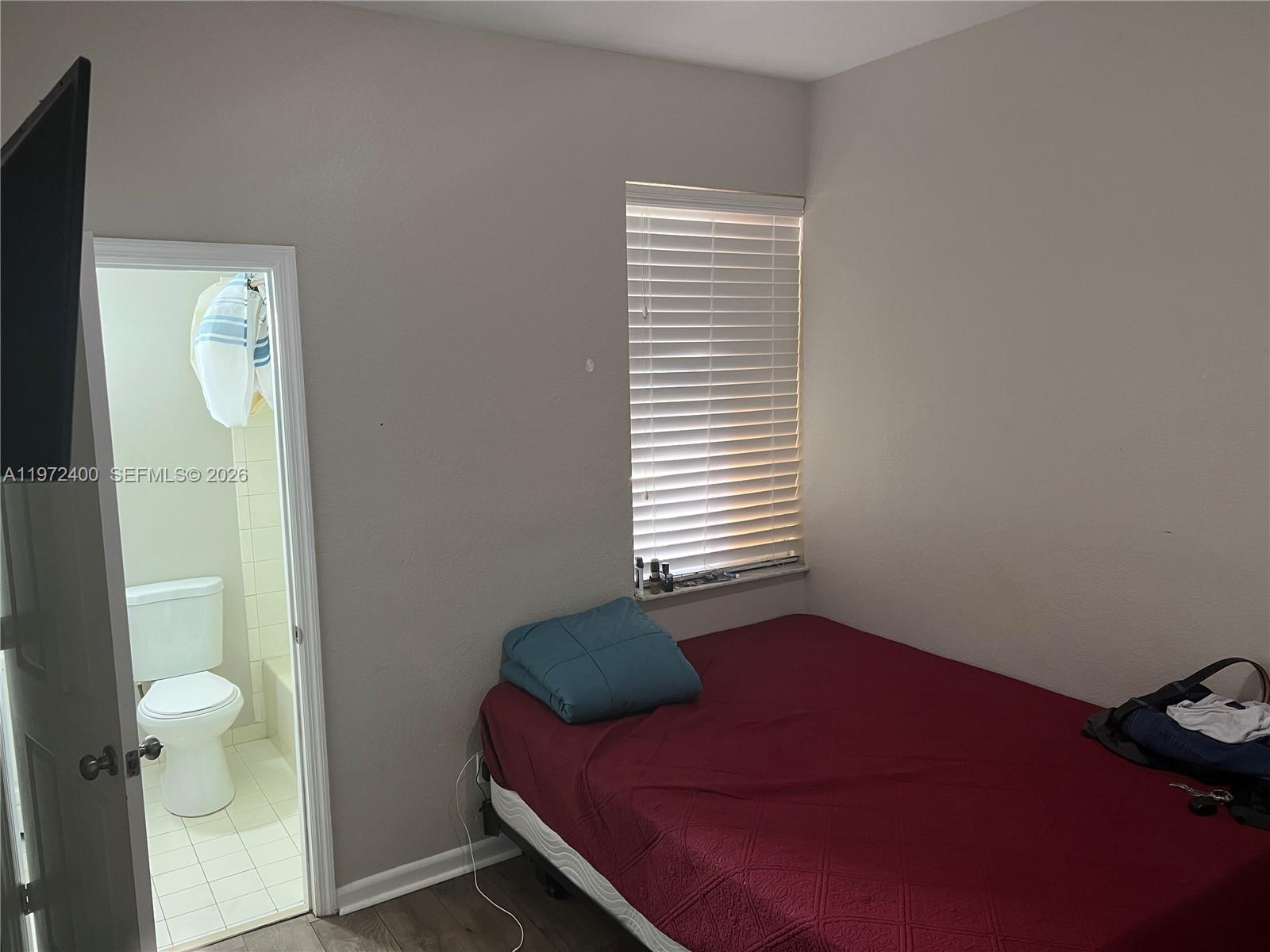 95 Southwest 15th Road Homestead, FL 33030 - Photo 25 of 42 a bedroom with a bed and a window