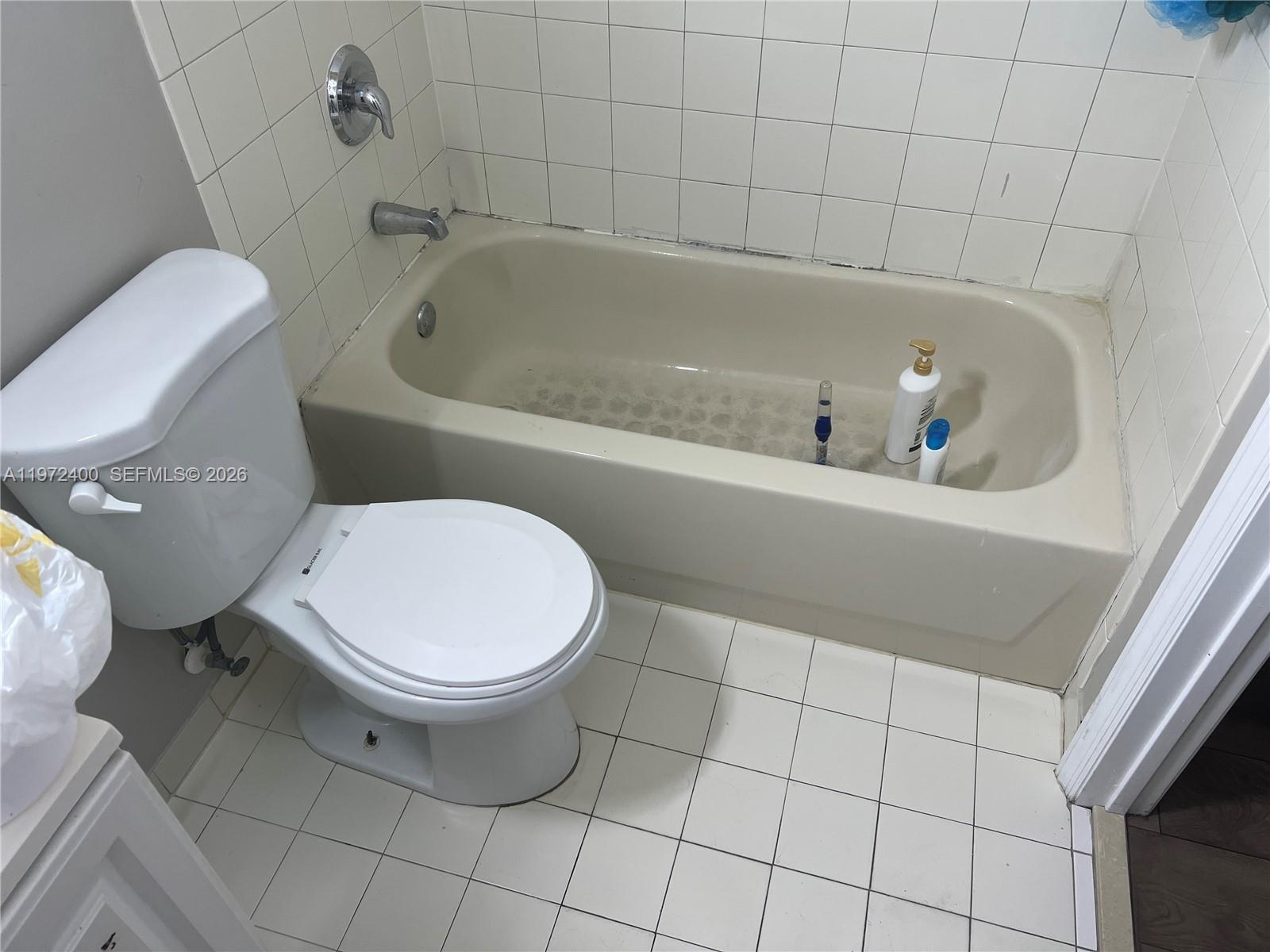 95 Southwest 15th Road Homestead, FL 33030 - Photo 28 of 42 a bathroom with a toilet and a bathtub