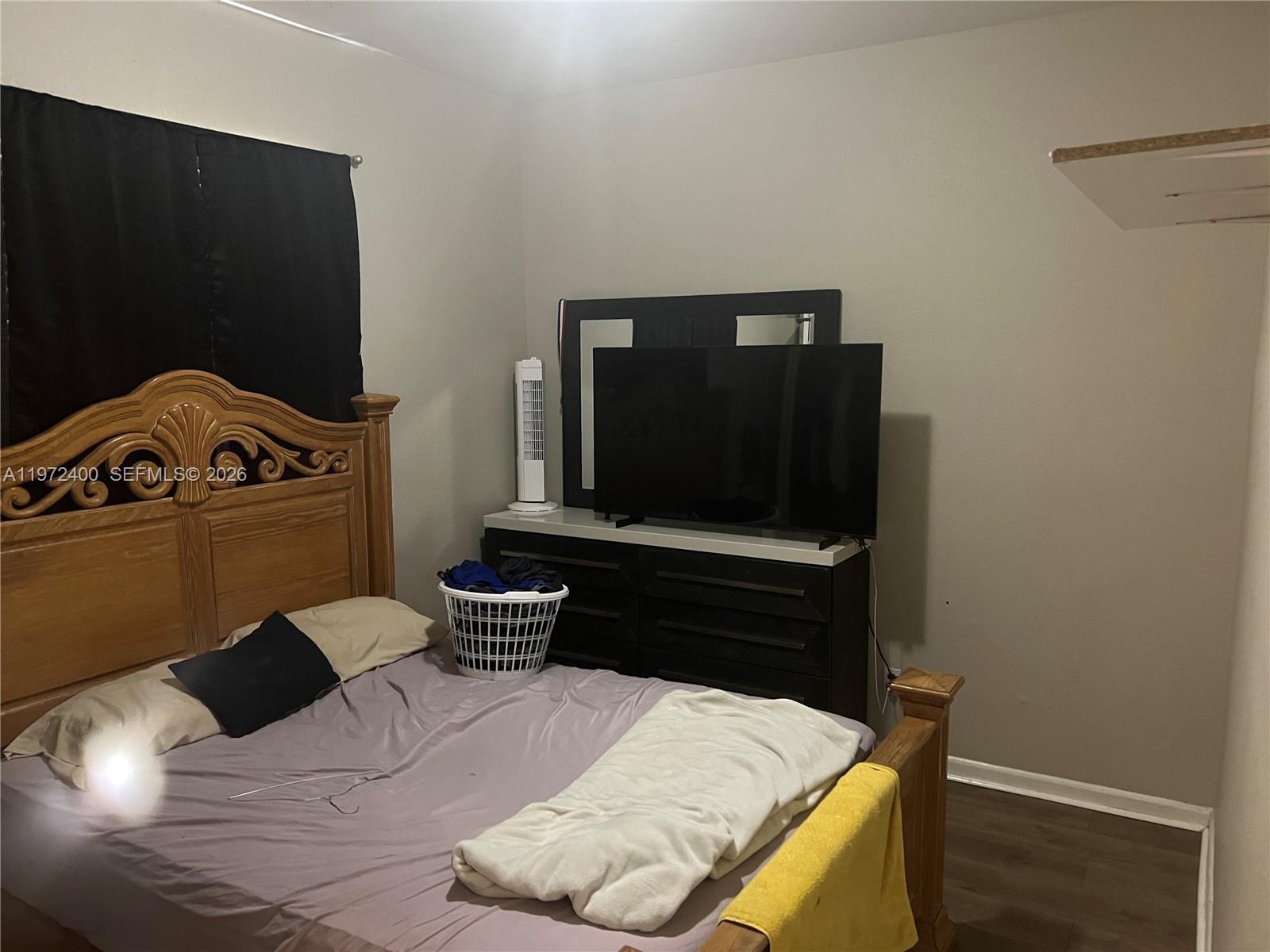 95 Southwest 15th Road Homestead, FL 33030 - Photo 30 of 42 a living room with a couch and a potted plant