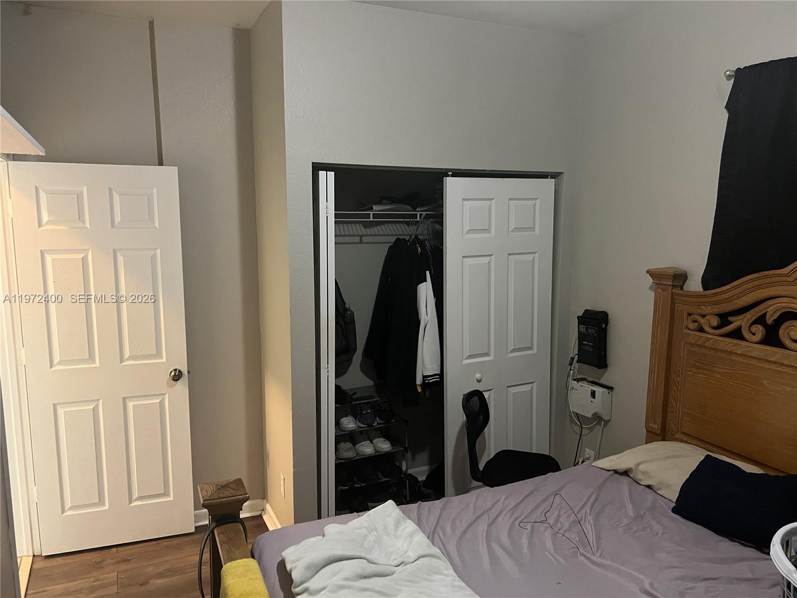 95 Southwest 15th Road Homestead, FL 33030 - Photo 32 of 42 a bedroom with a bed and a flat tv screen