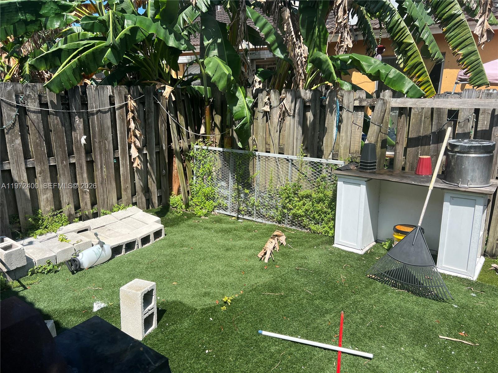 95 Southwest 15th Road Homestead, FL 33030 - Photo 34 of 42 a view of a wooden fence and a bench