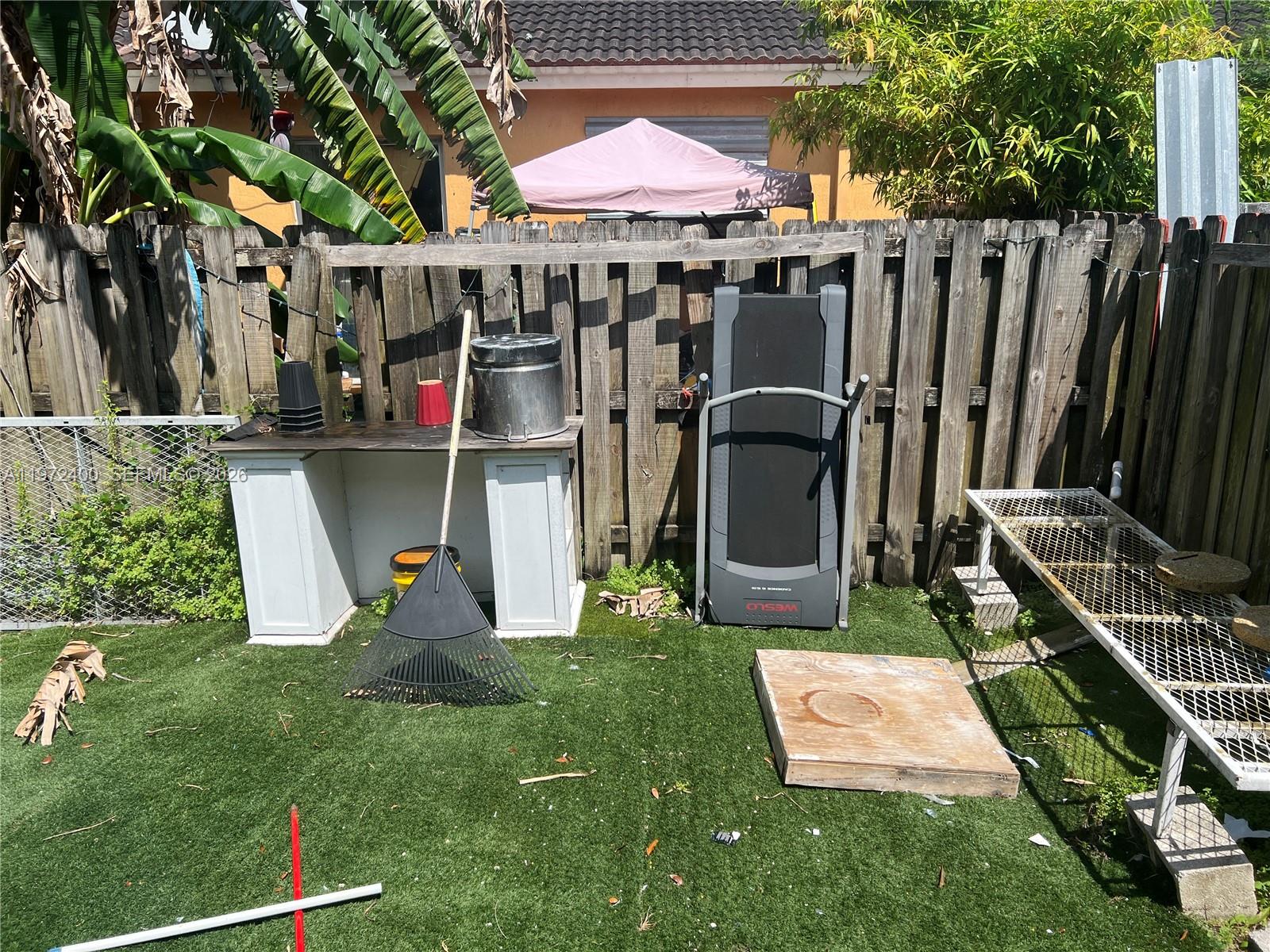 95 Southwest 15th Road Homestead, FL 33030 - Photo 35 of 42 a view of a backyard with sitting area and slide