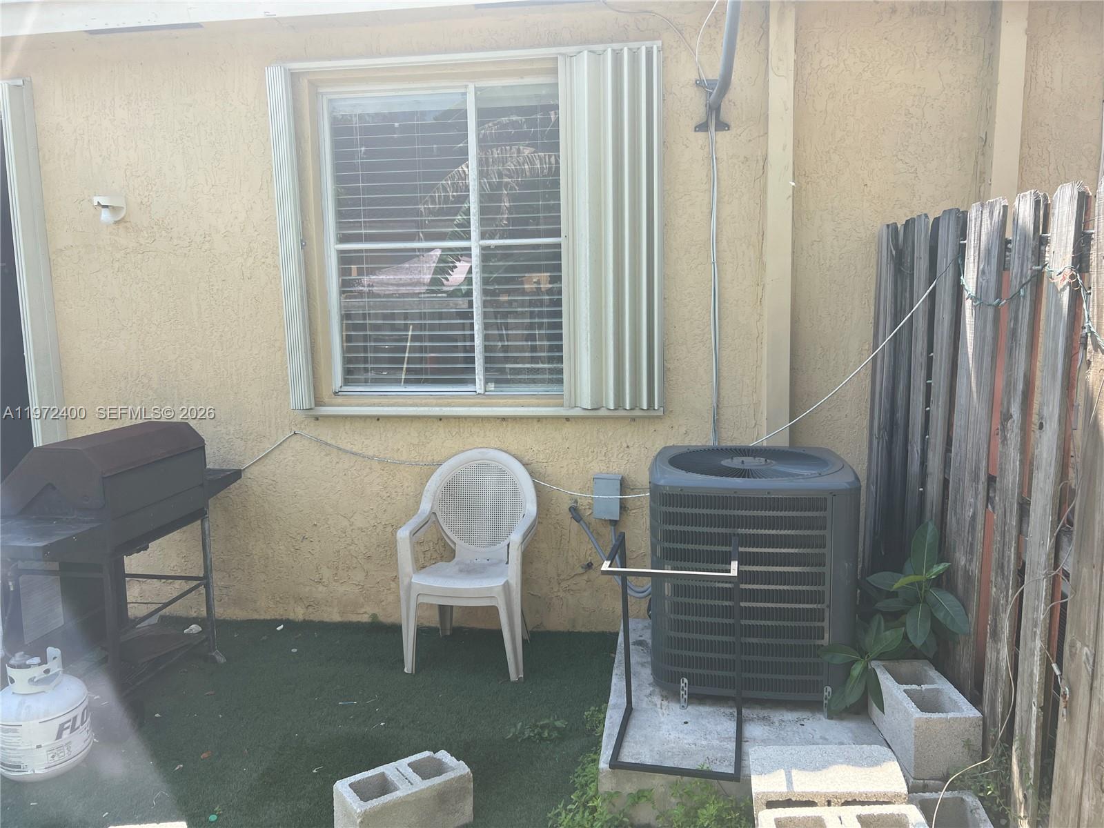 95 Southwest 15th Road Homestead, FL 33030 - Photo 36 of 42 a view of a room with a chair and a potted plant