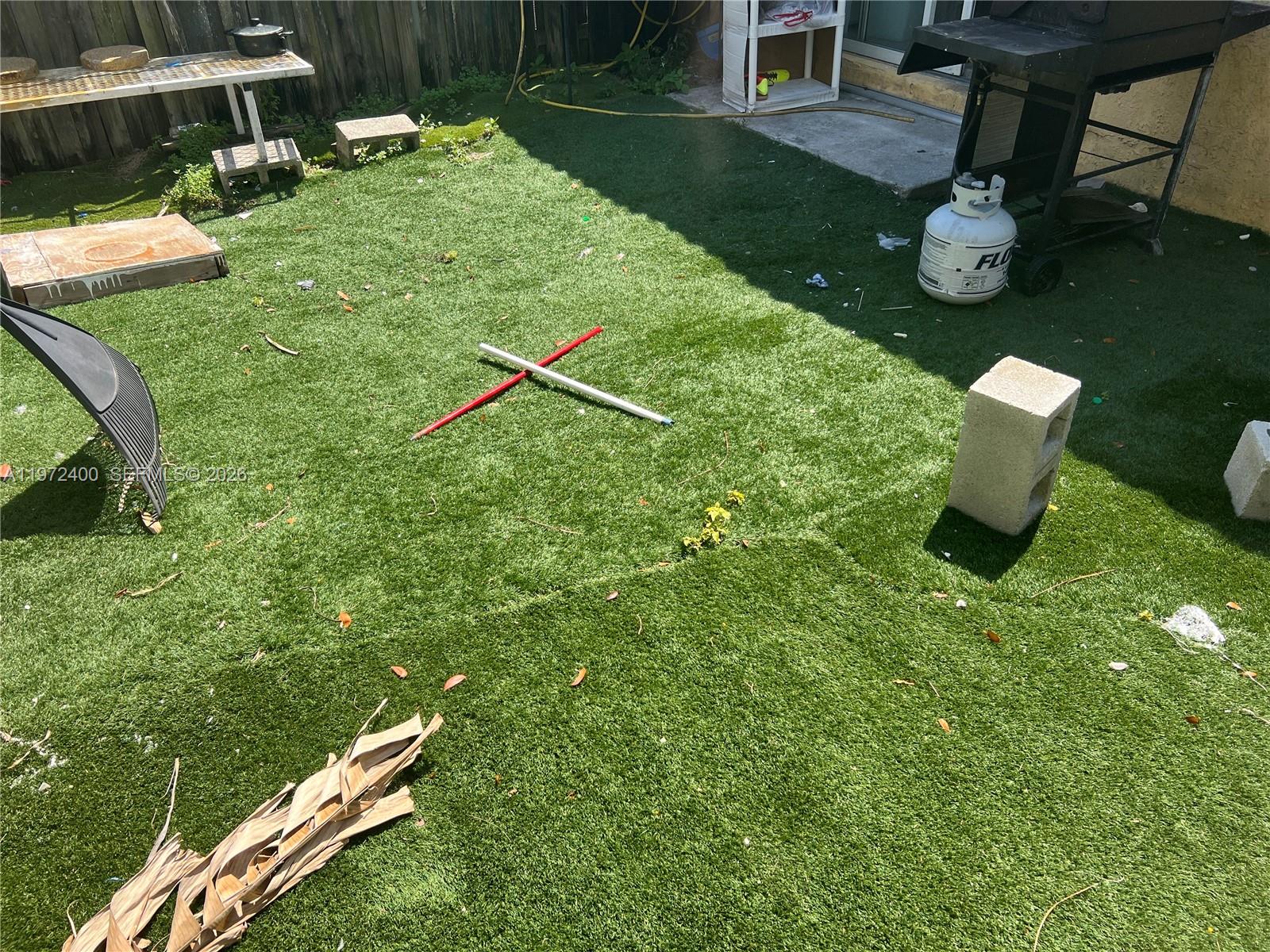 95 Southwest 15th Road Homestead, FL 33030 - Photo 42 of 42 a backyard of a house with table and chairs