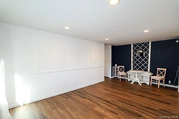 an empty room with wooden floor a ceiling fan and windows