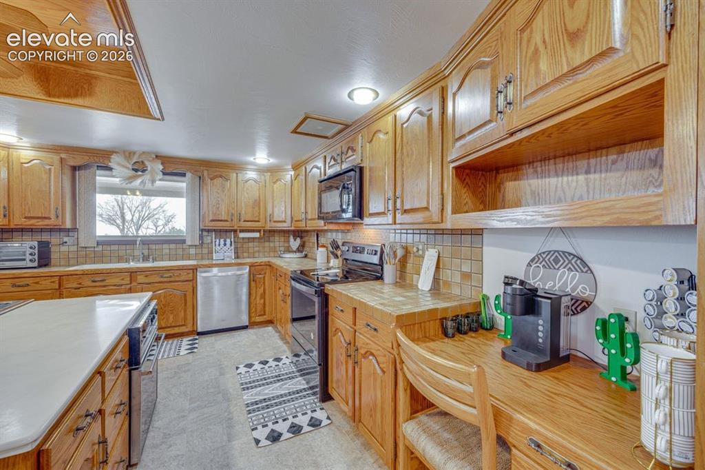 24760 Jones Road Calhan, CO 80808 - Photo 12 of 20 Kitchen with additional desk area