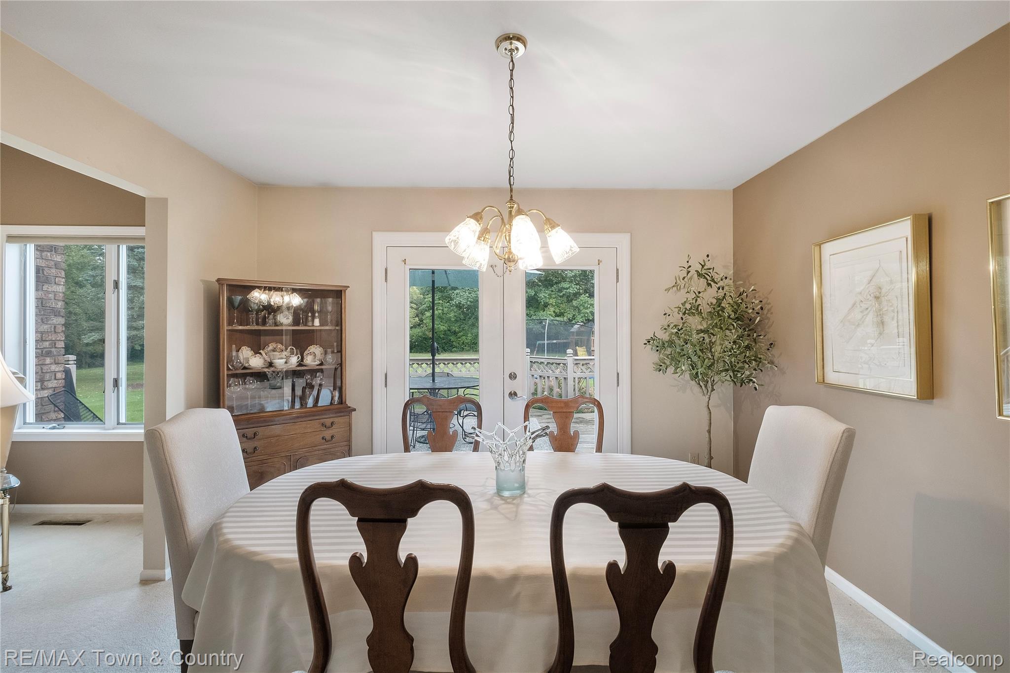 5464 North Seymour Road Flushing, MI 48433 - Photo 13 of 45 Recessed ceiling lighting, a chandelier light fixture, double glass panel doors, and a window with a sill
