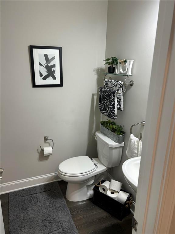 5860 Stargazer Way Cumming, GA 30028 - Photo 14 of 36 a white toilet sitting next to a bathroom sink