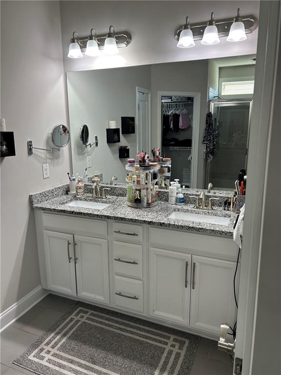 5860 Stargazer Way Cumming, GA 30028 - Photo 18 of 36 a bathroom with a sink and a mirror