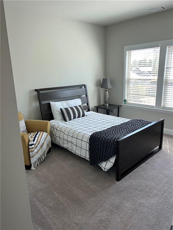 5860 Stargazer Way Cumming, GA 30028 - Photo 25 of 36 a bedroom with a bed and a couch