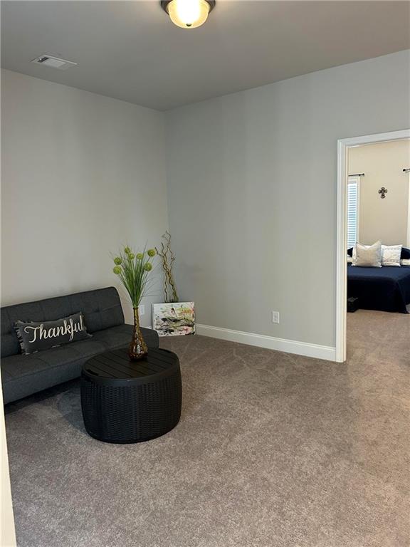 5860 Stargazer Way Cumming, GA 30028 - Photo 26 of 36 a room with a couch