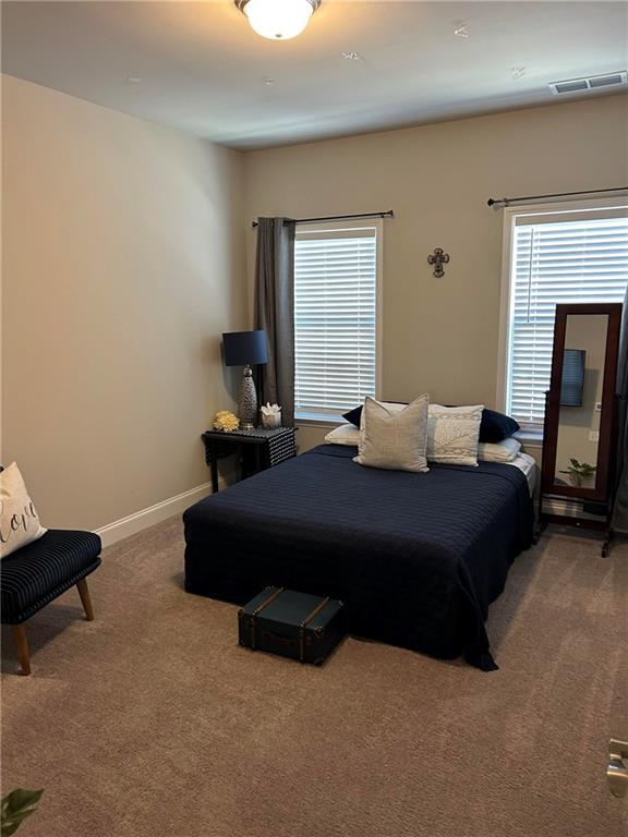 5860 Stargazer Way Cumming, GA 30028 - Photo 27 of 36 a bedroom with a bed lamp and a fireplace