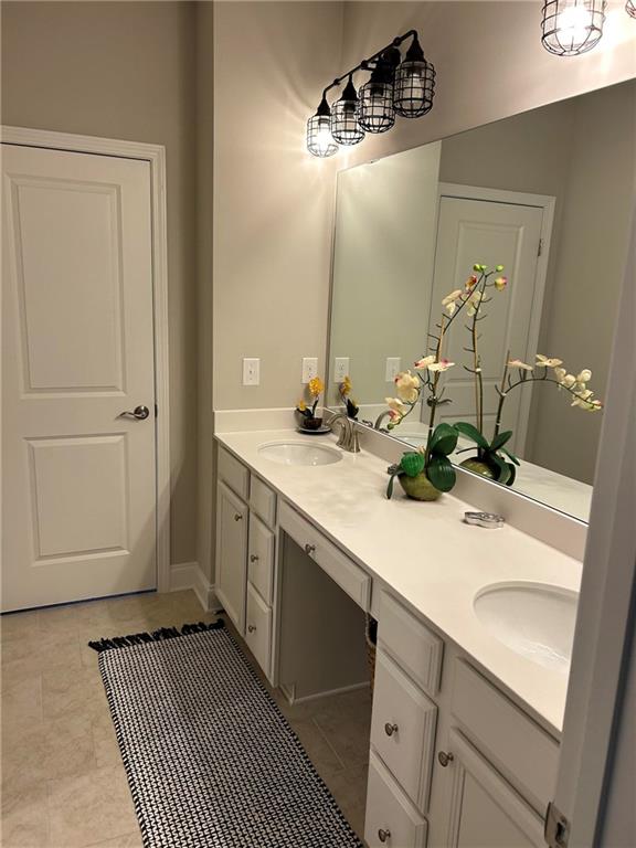 5860 Stargazer Way Cumming, GA 30028 - Photo 30 of 36 a bathroom with a sink and a mirror