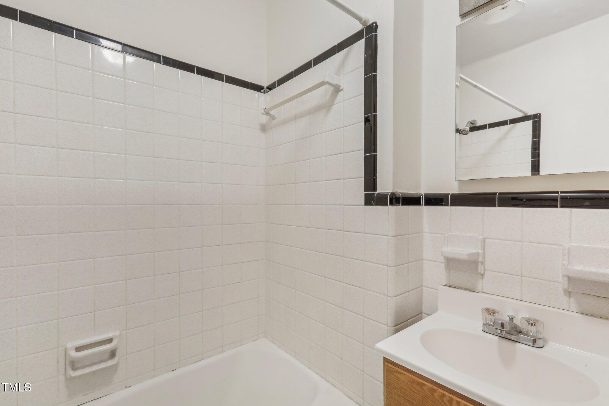 209 High House Road Cary, NC 27513 - Photo 14 of 40 a bathroom with a sink and shower