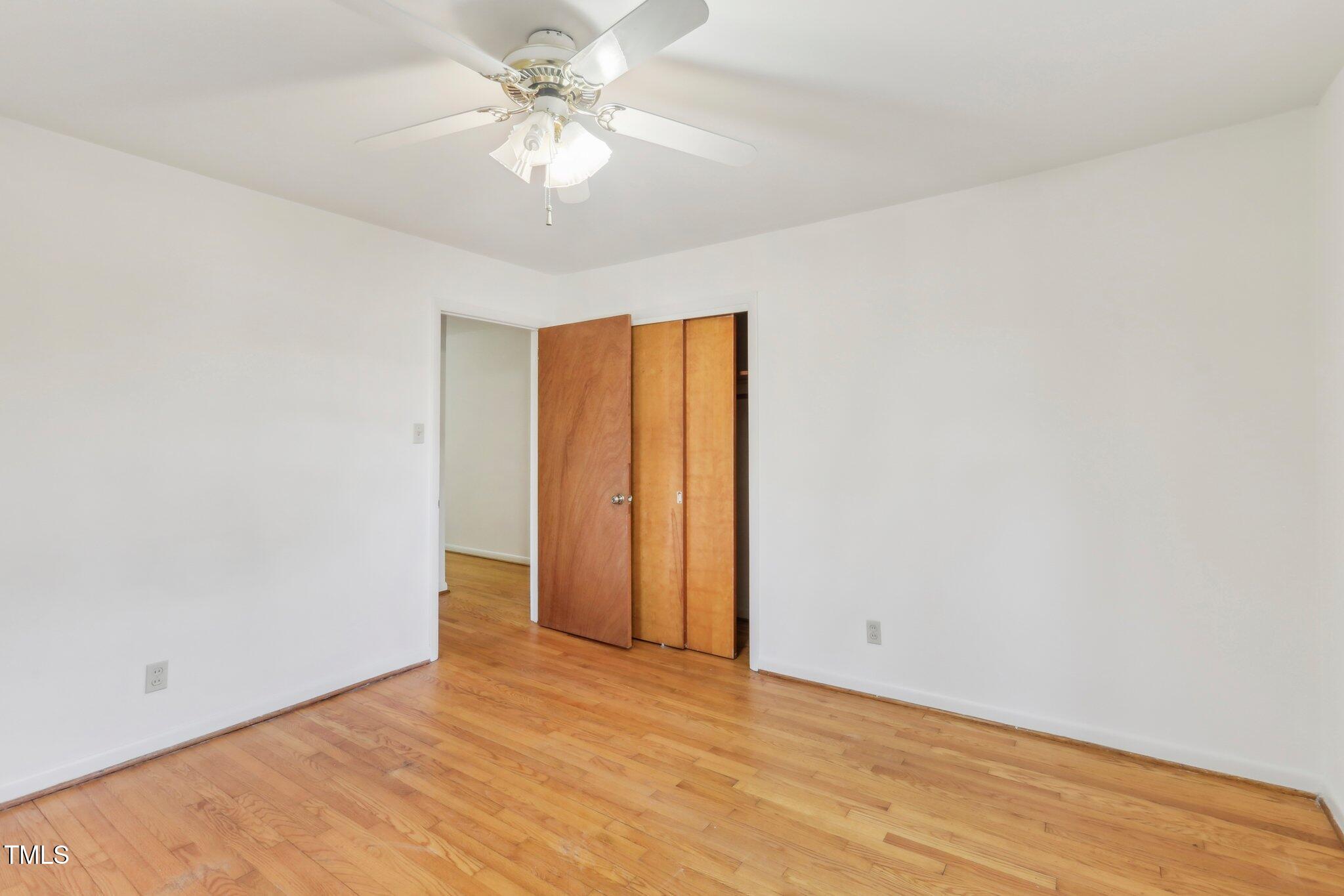 209 High House Road Cary, NC 27513 - Photo 26 of 40 an empty room with a chandelier fan and windows