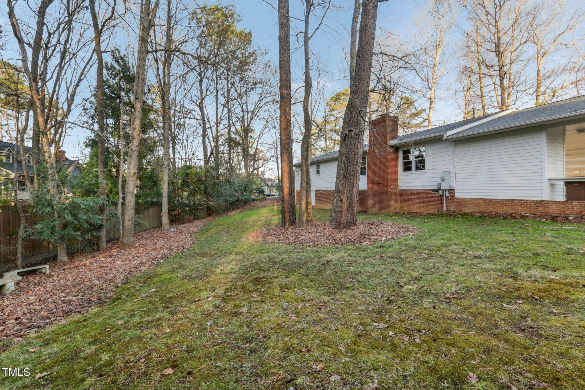 209 High House Road Cary, NC 27513 - Photo 37 of 40 a backyard of a house with lots of green space