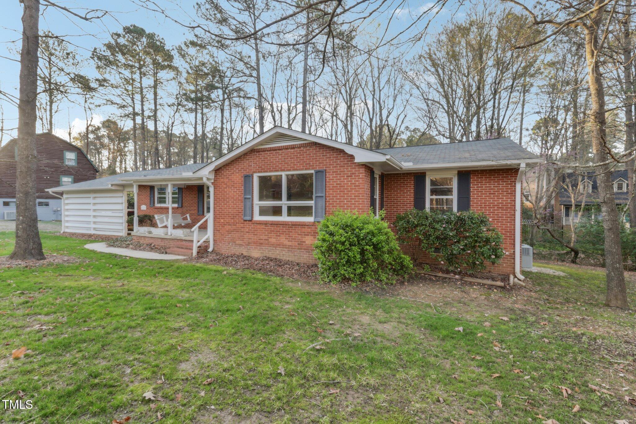 209 High House Road Cary, NC 27513 - Photo 39 of 40 a front view of a house with a garden